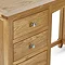 close up on wooden drawers with round metal handles of solid wood dressing table