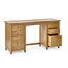 image cut out on white background of solid oak dressing table with six drawers, bottom right one open to indicate storage space