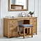 image of solid oak dressing table with padded stool, pushed up against light grey wall with wooden mirror hanging above