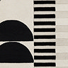 close up swatch image of cream rug with black geometric shapes, focus on colours and textures