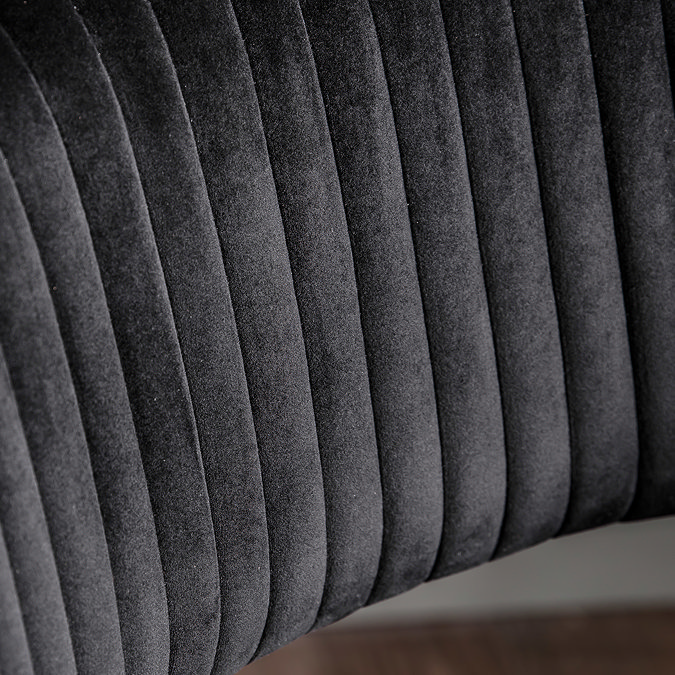close up on black velvet material of plush office swivel chair
