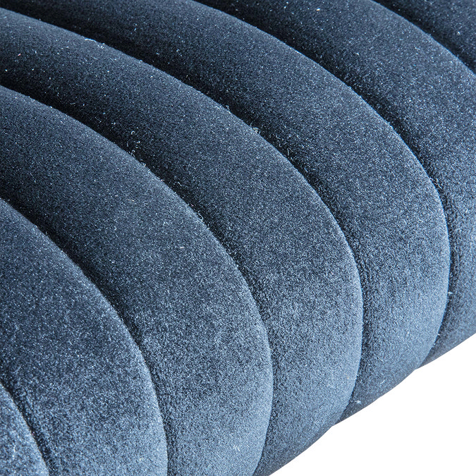 close up on plush seat of black velvet chair in different lighting to show blue tones