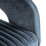 close up on curved arm of black velvet swivel chair, in different lighting to show blue tones of the material