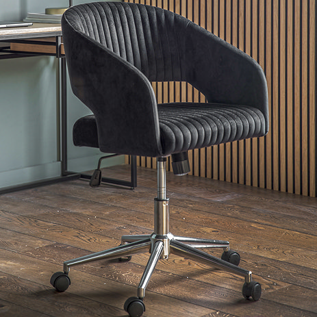 image of black stitched swivel chair with silver base on wooden floor of office