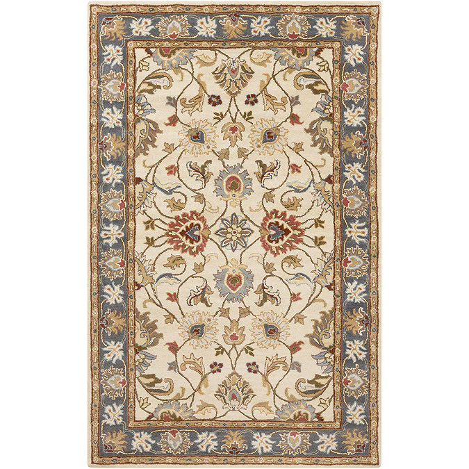 image cut out on white background of vintage floral rug in tan with brown, red, blue and yellow patterns