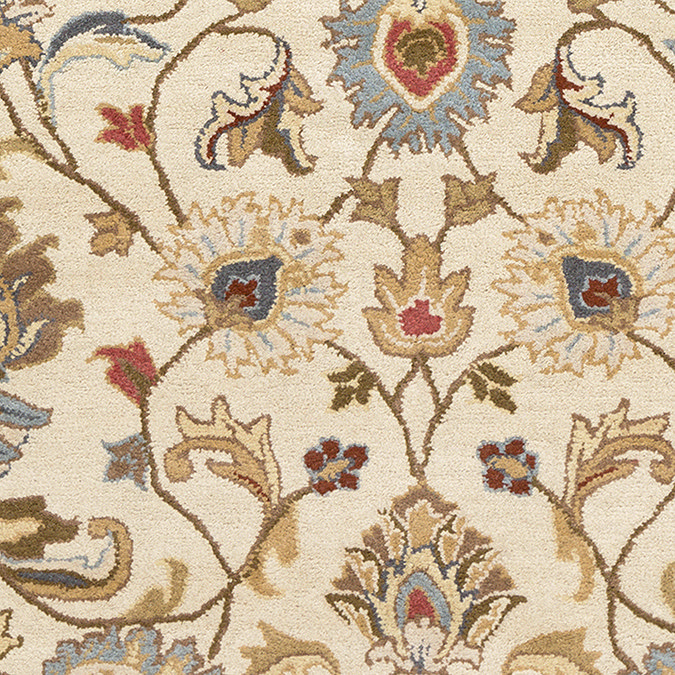 close up swatch image of tan coloured rug with intricate floral details