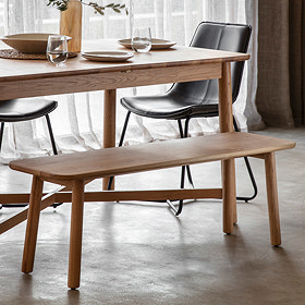 image of solid oak bench next to matching table, with slim, scandinavian inspired oak legs