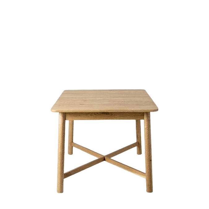 side on image of light oak dining table, cut out on white background