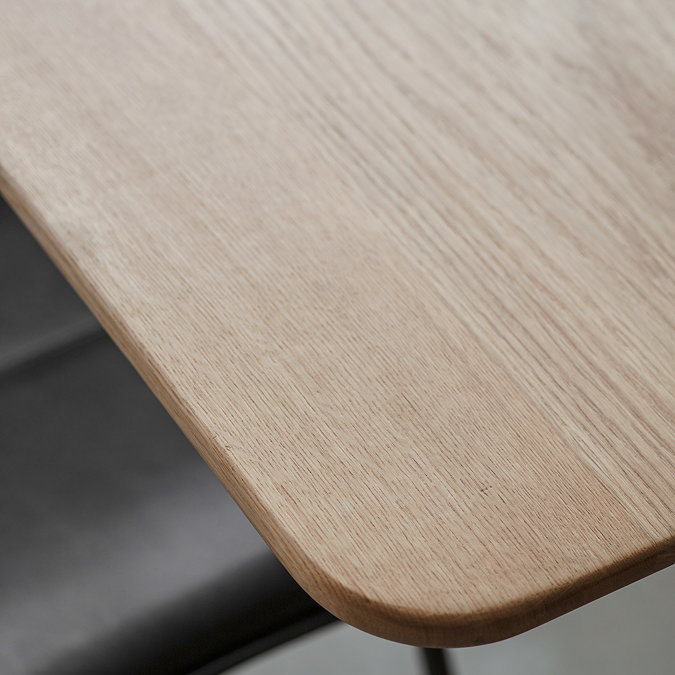 close up on corner of solid oak dining table with smooth edges