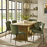 image of light wood rectangular dining table with fluted pillar legs, surrounded by six olive green high backed dining chairs on large cream rug
