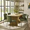 image of light wood rectangular dining table with fluted pillar legs, surrounded by six olive green high backed dining chairs on large cream rug