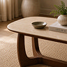 close up image of stone tabletop coffee table and walnut base