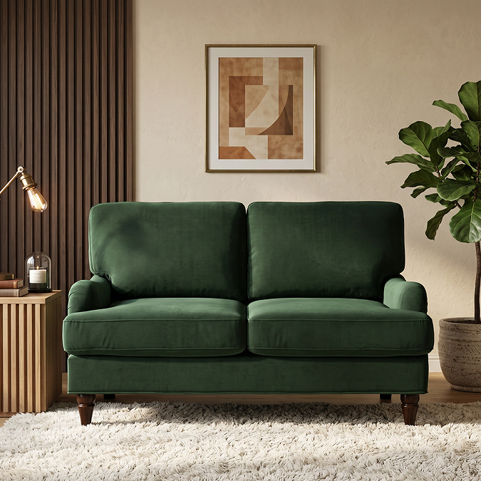 image of two seater forest green sofa with dark wood legs on plush rug