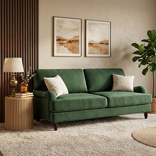 image of forest green velvet 3 seater sofa with warm wood legs on plush carpet, decorated with cushions