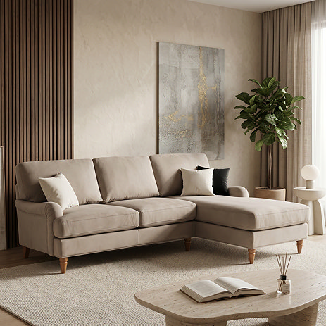 image of mink coloured velvet corner sofa with light wood legs, on soft rug in living room scene