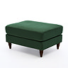 angled image of forest green velvet pouffe with dark wood legs
