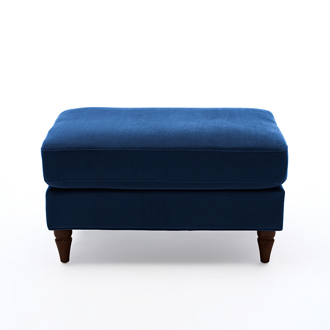 side on cut out image of navy blue velvet pouffe with dark wood legs