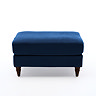 side on cut out image of navy blue velvet pouffe with dark wood legs