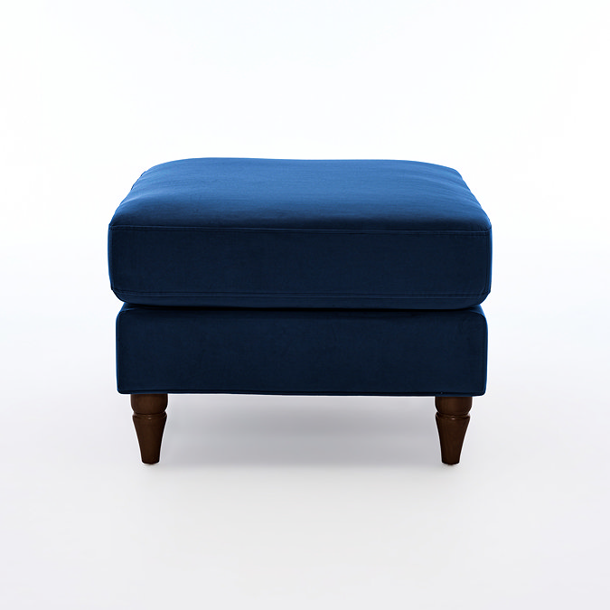 side on cut out image of navy blue pouffe with dark wood legs