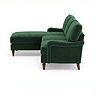 side on cut out image of velvet green corner sofa with dark wood legs