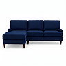 front on cut out image of navy blue velvet right seat corner sofa with dark wood legs