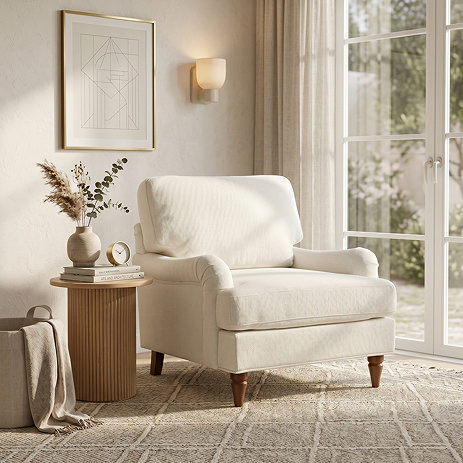 image of beige woven armchair with warm wood legs on plush carpet