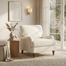 image of beige woven armchair with warm wood legs on plush carpet