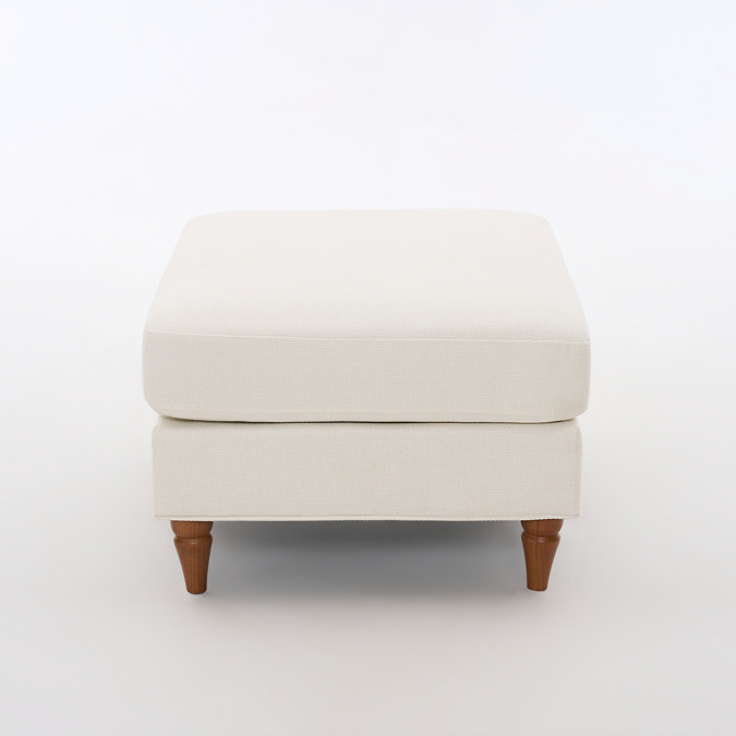 side on cut out image of beige woven pouffe with warm wood legs