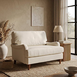 image of woven fabric beige snuggle chair with warm wood legs in living room on rug