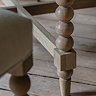close up on bobbin wood legs of limed oak round dining table