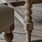 close up on bobbin wood legs of limed oak round dining table