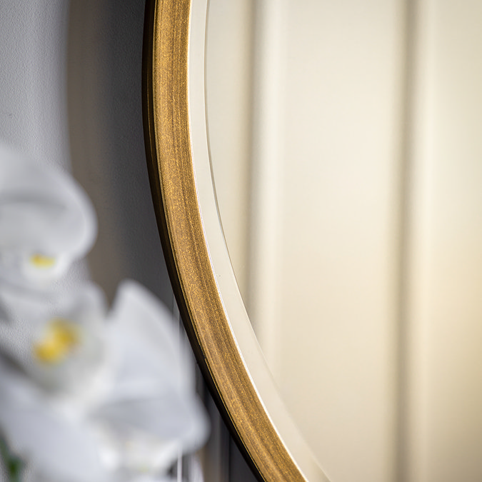close up image of thin antique gold frame of mirror