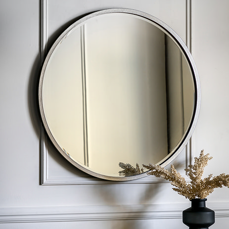 image of antique silver round mirror on grey panelled wall