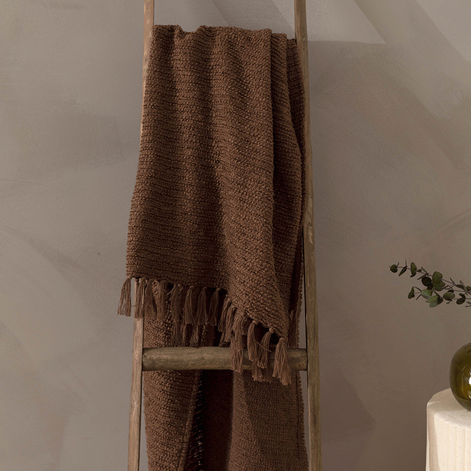 image of boucle chocolate brown throw folded over a ladder
