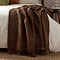 image of cocoa brown throw draped over the edge of a bed with cream duvet cover