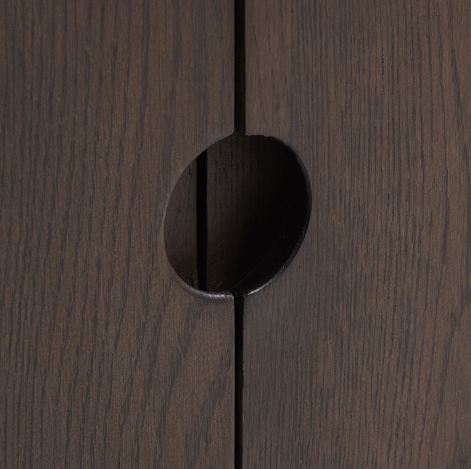 close up image of cut out in wood at centre of dark oak cabinet which acts as subtle handle