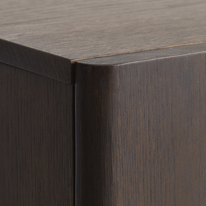 close up image of edge of dark oak cabinet highlighting smooth dark oak grain