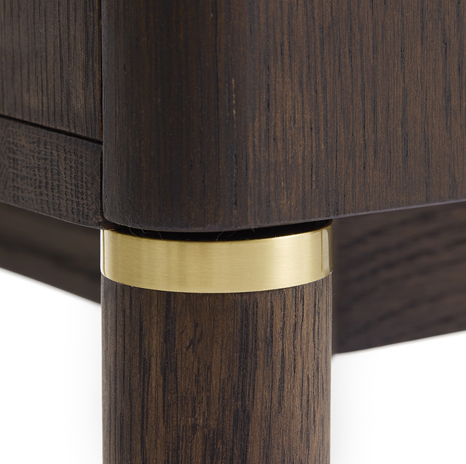 close up image of legs of dark oak cabinet with gold band inlay detail