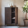 image of dark oak cabinet against a beige wall with right hand door open to reveal shelving space within