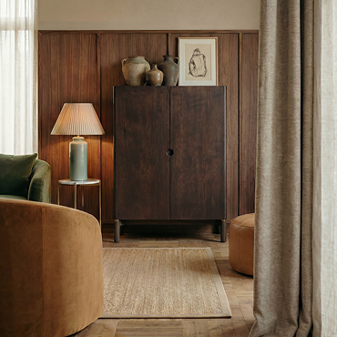 close up image of cut out in wood at centre of dark oak cabinet which acts as subtle handle