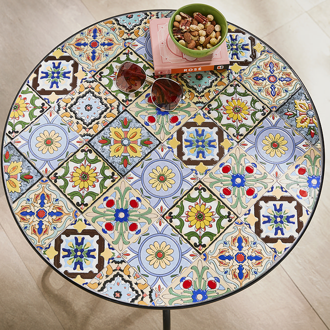 close up image of colourful tiles of round bistro table