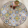 close up image of colourful tiles of round bistro table