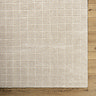 close up image of corner of lined beige rug