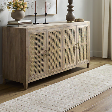 close up image on corner of beige square lined rug with corner folded over to reveal material underneath