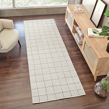 ivory runner on dark wood flooring with squared pattern