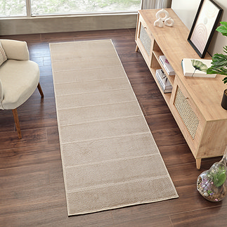 image of beige lined runner on dark wood flooring
