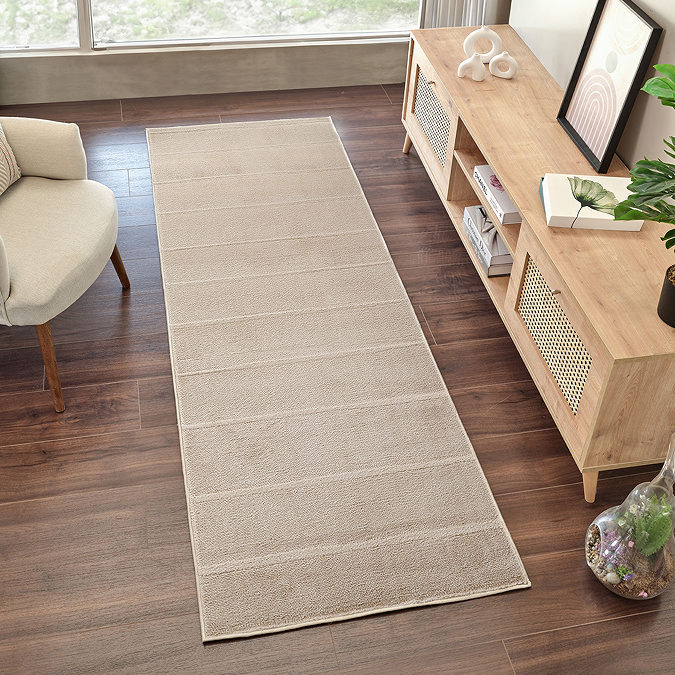 image of beige lined runner on dark wood flooring