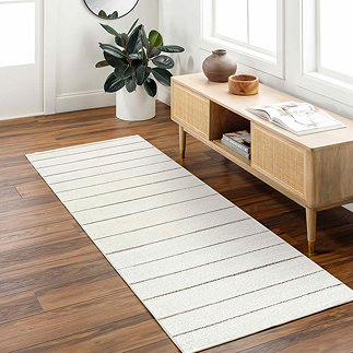 image of striped runner in ivory and beige on dark wood flooring