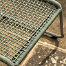 close up of green woven rope material of garden chair