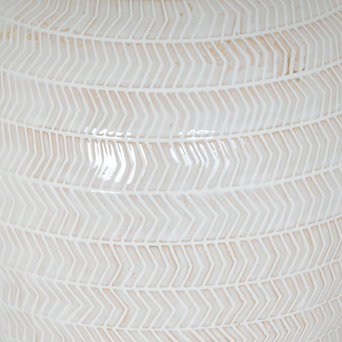 close up on chevron pattern of white ceramic table lamp base